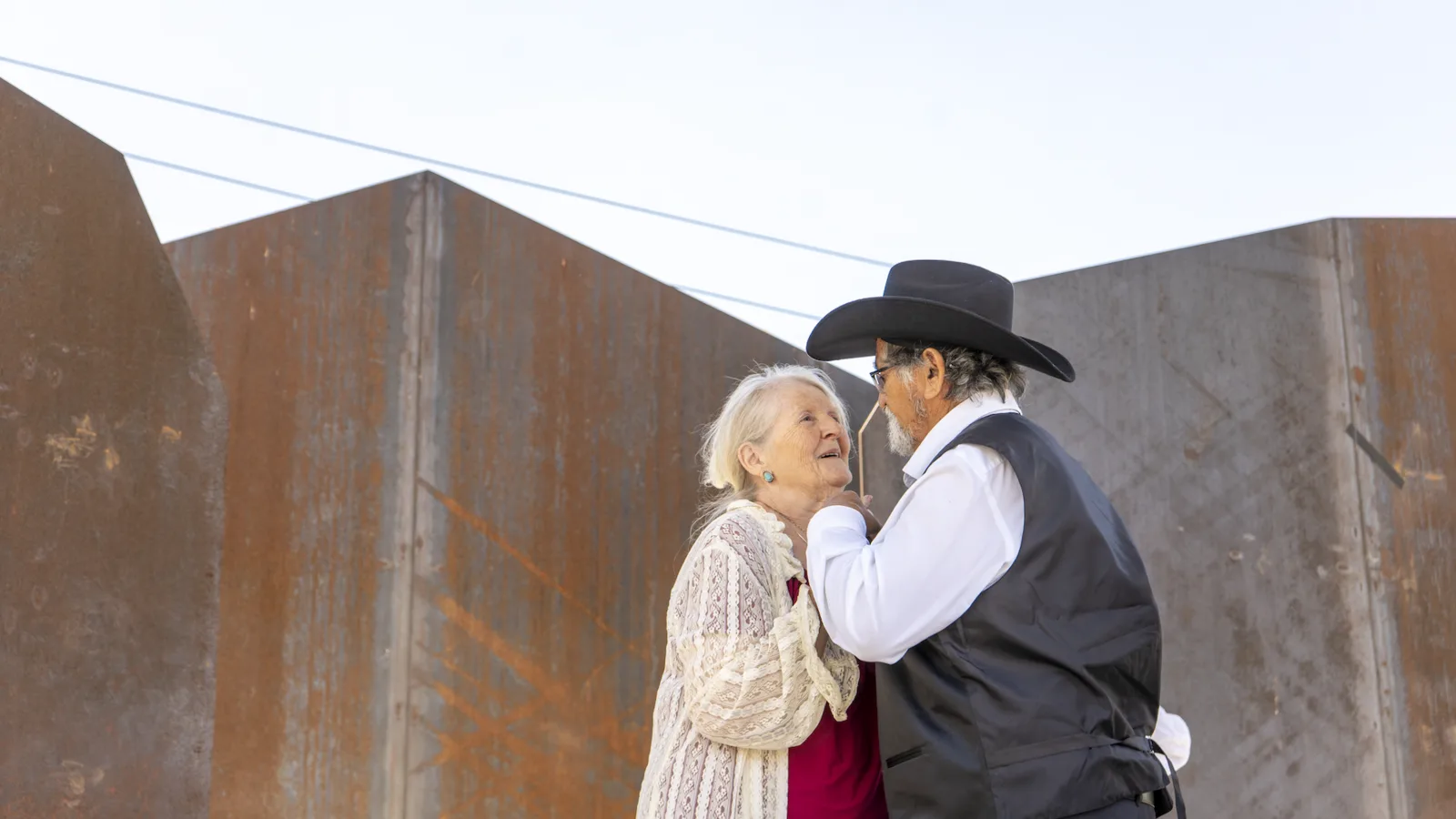 Two dance partners face each other during an outdoor performance.