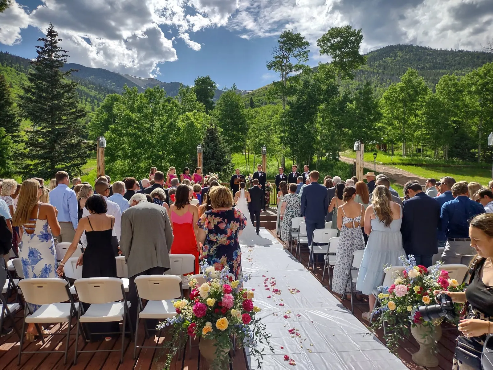 Wedding guests seated outdoors at Cuchara Mountain Mercantile.