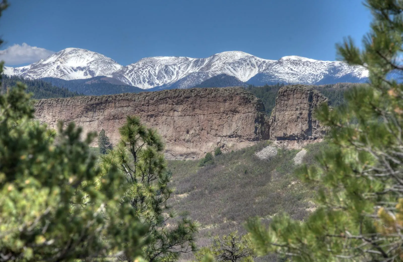 Snowy mountains and a sunlit rock formation near Cuchara.