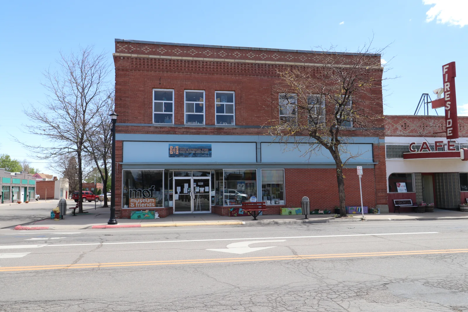 Wide street view of the Museum of Friends and Roof and Dick Building in downtown Walsenburg.