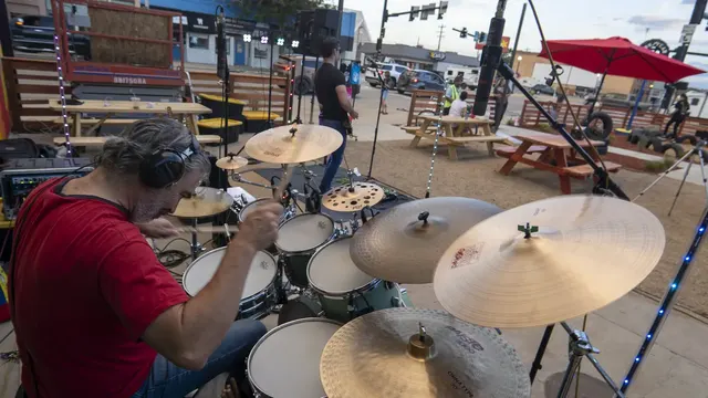 Nathan, Vegan Shark's drummer, performs on a street stage outside Gub Gub's in Walsenburg.