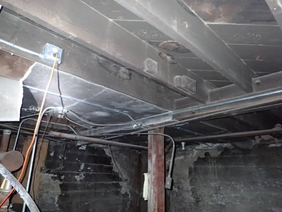Board-formed concrete foundation wall in the basement mechanical room.