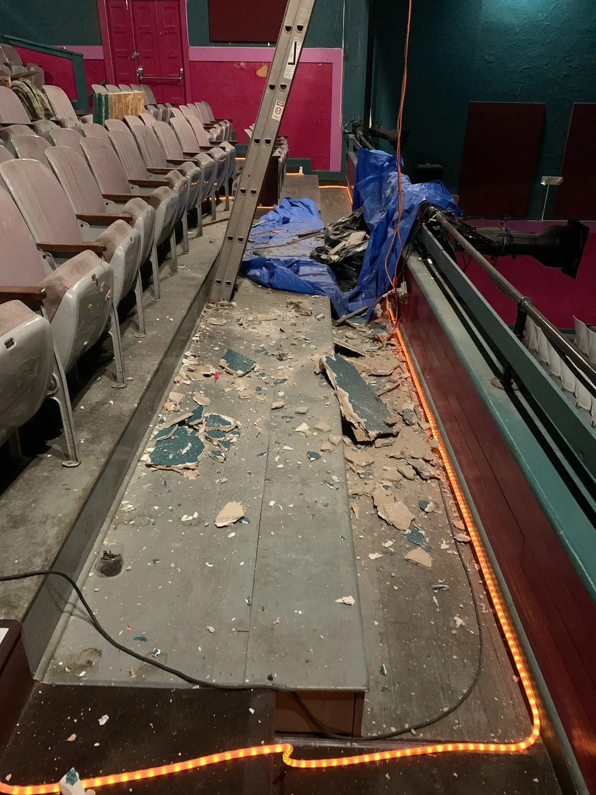 Auditorium seating and an opened work area prepared for access to the roof structure.