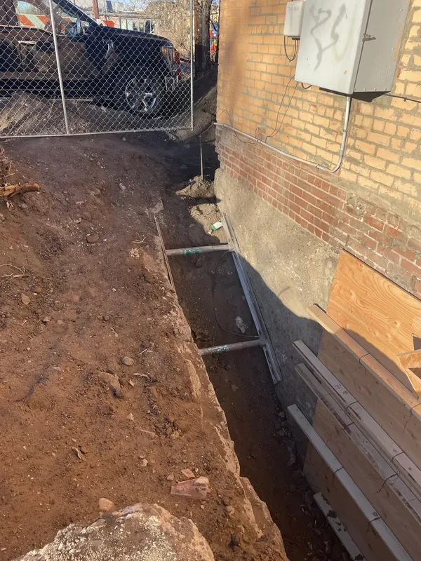 Excavation and formwork beside the theatre’s exterior wall.